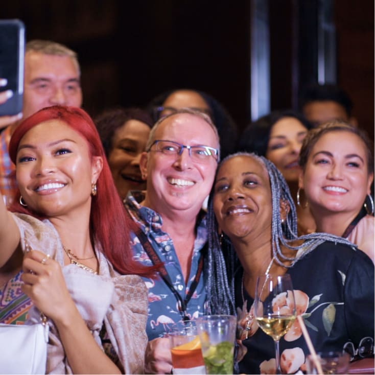 woman taking photo with members at an event